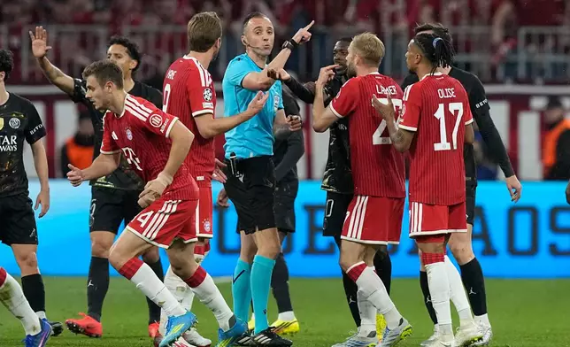 Bayern players react after referee Joao Pinheiro's decision during the Champions League semifinal second leg soccer match between Bayern Munich and Paris Saint Germain in Munich, Germany, Wednesday, May 6, 2026. (AP Photo/Martin Meissner)