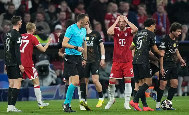 Bayern's Harry Kane, center, reacts to a call by referee Joao Pinheiro during the Champions League semifinal second leg soccer match between Bayern Munich and Paris Saint Germain in Munich, Germany, Wednesday, May 6, 2026. (AP Photo/Matthias Schrader)