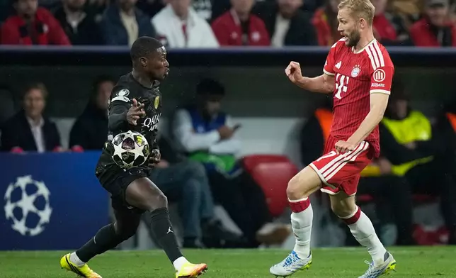 Bayern's Konrad Laimer, right, challenges PSG's Nuno Mendes during the Champions League semifinal second leg soccer match between Bayern Munich and Paris Saint Germain in Munich, Germany, Wednesday, May 6, 2026. (AP Photo/Matthias Schrader)