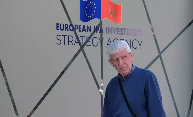 A man walks on a street in Montenegro's capital Podgorica, Monday, May 18, 2026. (AP Photo/Risto Bozovic)