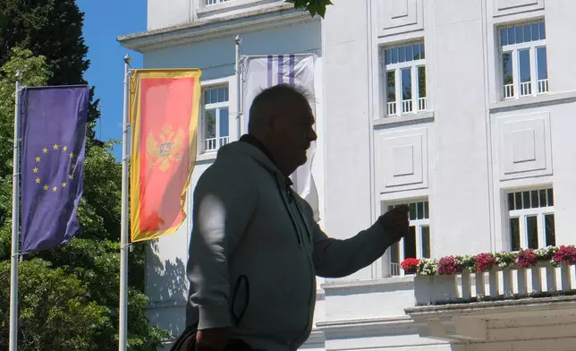 A man walks on a street in Montenegro's capital Podgorica, Monday, May 18, 2026. (AP Photo/Risto Bozovic)