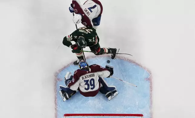 Colorado Avalanche defenseman Devon Toews (7) and goaltender MacKenzie Blackwood (39) defend the goal while pressured by Minnesota Wild center Nico Sturm (78) during the third period of Game 3 of an NHL Stanley Cup hockey second-round playoff series Saturday, May 9, 2026, in St. Paul, Minn. (AP Photo/Abbie Parr)