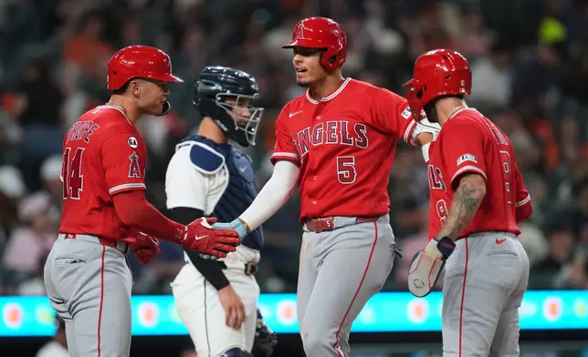 Los Angeles Angels' Vaughn Grissom (5) celebrates his grand slam with Logan O'Hoppe (14) and Zach Neto (9) against the Detroit Tigers during the eighth inning of a baseball game Tuesday, May 26, 2026, in Detroit. (AP Photo/Paul Sancya)
