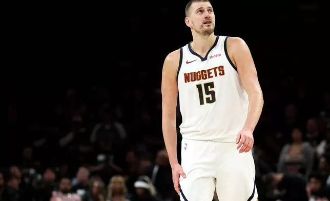 Denver Nuggets center Nikola Jokic (15) looks on during the second half of Game 6 of a first-round NBA basketball playoffs series against the Minnesota Timberwolves, Thursday, April 30, 2026, in Minneapolis. (AP Photo/Matt Krohn)