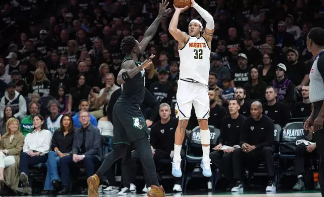 Denver Nuggets forward Aaron Gordon (32) goes up to shoot over Minnesota Timberwolves forward Julius Randle, center left, during the first half of Game 4 of a first-round NBA basketball playoff series, Saturday, April 25, 2026, in Minneapolis. (AP Photo/Abbie Parr)
