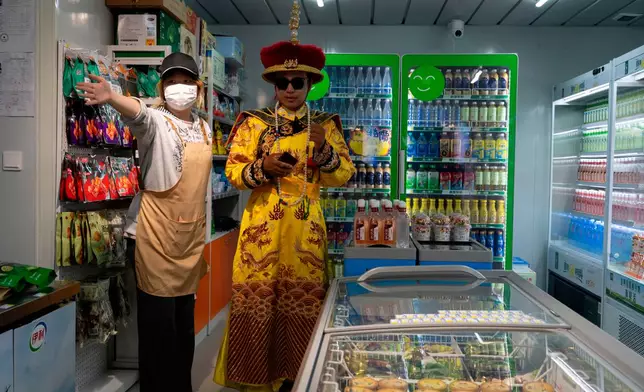 A man dressed as the emperor visits a convenience along the popular Wangfujing shopping street in Beijing, Wednesday, May 6, 2026. (AP Photo/Ng Han Guan)