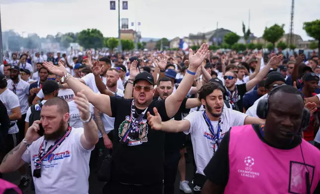 PSG supporters are accompanied by security ahead of the Champions League final soccer match between Paris Saint-Germain and Arsenal in Budapest, Hungary, Saturday, May 30, 2026. (AP Photo/Rudolf Karancsi-Albert)