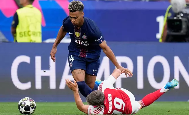 Arsenal's Leandro Trossard falls to the ground in a clash with PSG's Desire Doue during the Champions League final soccer match between Paris Saint-Germain and Arsenal in Budapest, Hungary, Saturday, May 30, 2026. (AP Photo/Petr Josek)