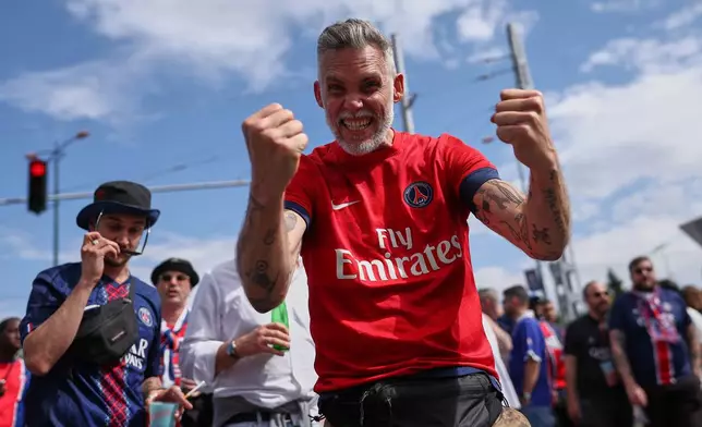 PSG supporters react as they make their way to the stadium ahead of the Champions League final soccer match between Paris Saint-Germain and Arsenal in Budapest, Hungary, Saturday, May 30, 2026. (AP Photo/Rudolf Karancsi-Albert)