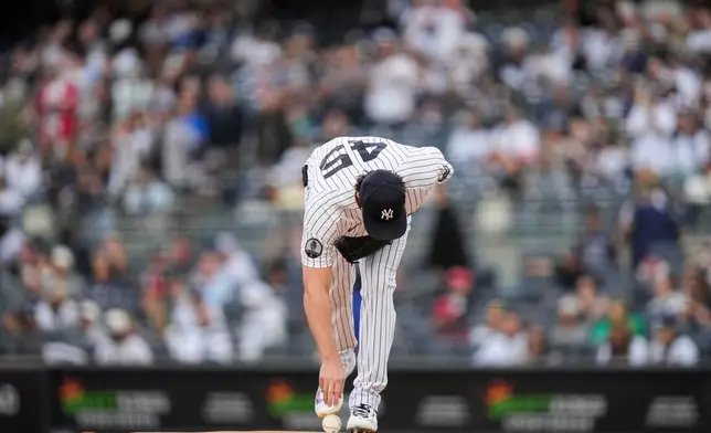 New York Yankees pitcher Gerrit Cole picks up the ball before a baseball game against the Tampa Bay Rays, Friday, May 22, 2026, in New York. (AP Photo/Yuki Iwamura)