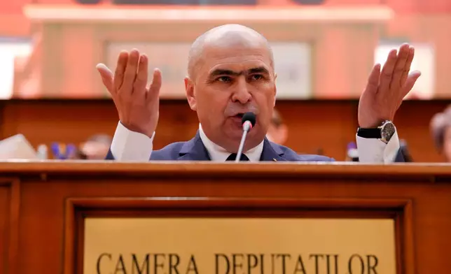 Romanian Prime Minister Ilie Bolojan addresses a parliament session ahead of a no confidence vote in Bucharest, Romania, Tuesday, May 5, 2026. (AP Photo/Vadim Ghirda)