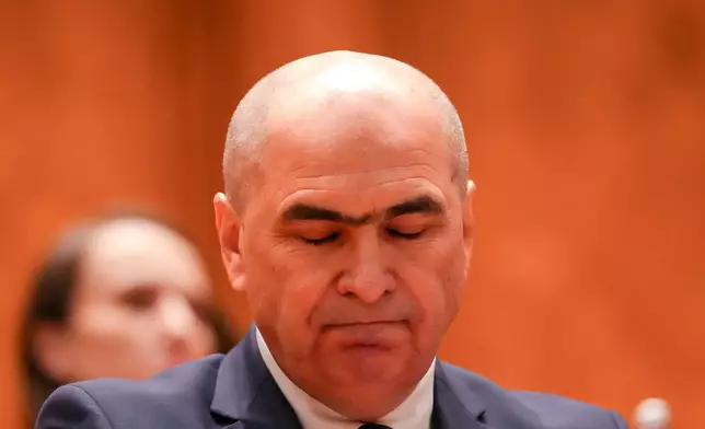 Romanian Prime Minister Ilie Bolojan reacts during a parliament session ahead of a no confidence vote in Bucharest, Romania, Tuesday, May 5, 2026. (AP Photo/Vadim Ghirda)