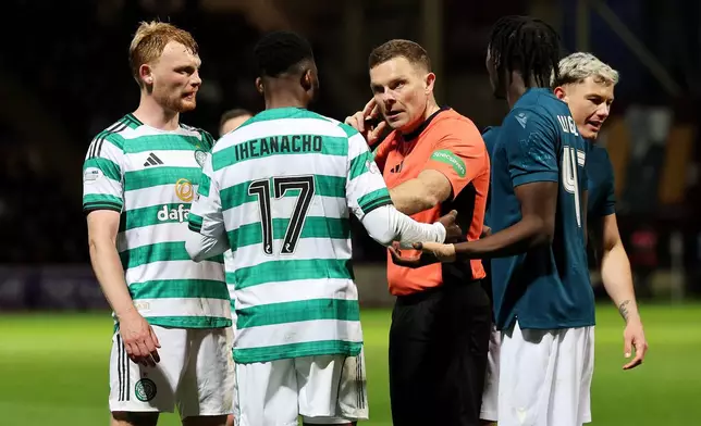 Referee John Beaton, center, speaks to Celtic's Kelechi Iheanacho before going to the VAR monitor and awarding a penalty to Celtic during the Scottish Premiership soccer match between Motherwell and Celtic, Wednesday May 13, 2026, in Motherwell, Scotland. (Robert Perry/PA via AP)