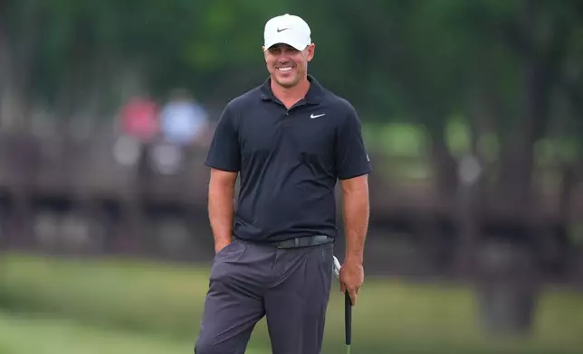 Brooks Koepka smiles while standing on the ninth green during of the first round of the Byron Nelson golf tournament in McKinney, Texas, Thursday, May 21, 2026. (AP Photo/LM Otero)
