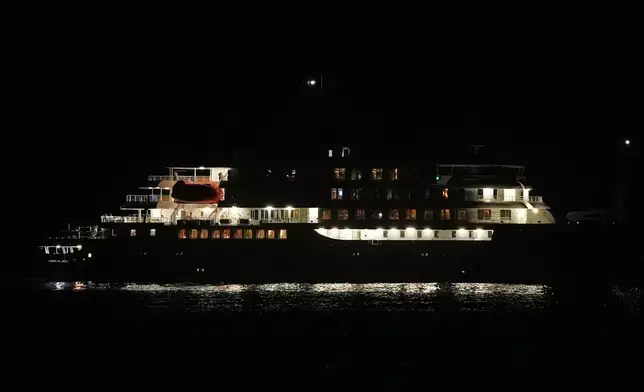 A night view of the MV Hondius cruise ship anchored at a port in Praia, Cape Verde, Tuesday, May 5, 2026. (AP Photo/Misper Apawu)