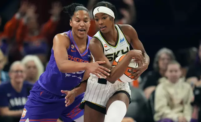 Chicago Sky forward Rickea Jackson, right, keeps the ball away from Phoenix Mercury forward Alyssa Thomas during the first half of a WNBA basketball game, Friday, May 15, 2026, in Phoenix. (AP Photo/Ross D. Franklin)
