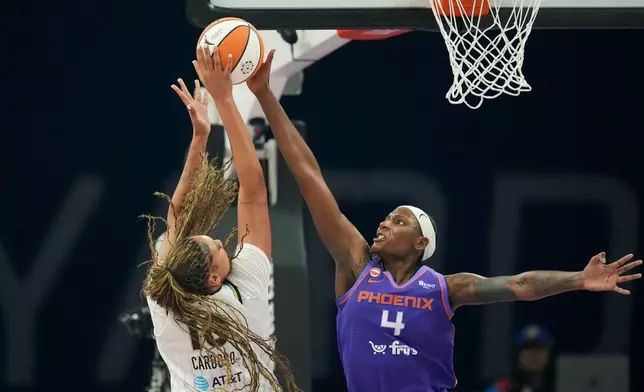 Phoenix Mercury center Natasha Mack (4) blocks a shot by Chicago Sky center Kamilla Cardoso during the first half of a WNBA basketball game, Friday, May 15, 2026, in Phoenix. (AP Photo/Ross D. Franklin)