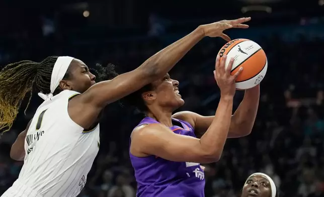 Chicago Sky center Elizabeth Williams (1) blocks a shot by Phoenix Mercury forward Alyssa Thomas during the first half of a WNBA basketball game, Friday, May 15, 2026, in Phoenix. (AP Photo/Ross D. Franklin)