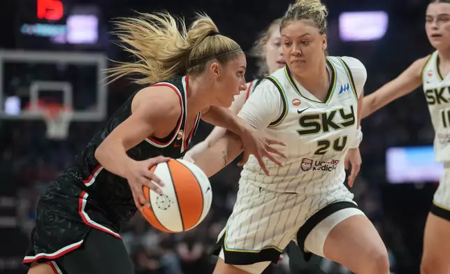 Portland Fire guard Sarah Ashlee Barker, left, tries to get past Chicago Sky guard Rachel Banham (24) during the first half of a WNBA basketball game on Saturday, May 9, 2026, in Portland, Ore. (AP Photo/Jenny Kane)