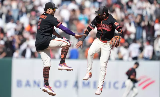 San Francisco Giants shortstop Willy Adames, left, celebrates with second baseman Luis Arraez after a baseball game against the Chicago White Sox Saturday, May 23, 2026, in San Francisco. (AP Photo/Jeff Chiu)