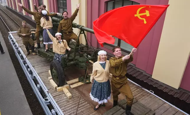Actors attend a historical reenactment depicting the arrival of trains after the end of the war as a part of celebrations ahead of the 81st anniversary of the Soviet Union's victory over Nazi Germany during World War II, at the Baltiysky railway station in St. Petersburg, Russia, Thursday, May 7, 2026. (AP Photo/Dmitri Lovetsky)