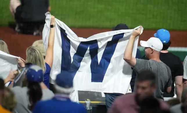 Chicago Cubs fans celebrate after the final out of a baseball game between the Pittsburgh Pirates and the Chicago Cubs in Pittsburgh, Wednesday, May 27, 2026. (AP Photo/Gene J. Puskar)
