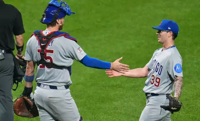 Chicago Cubs pitcher Ethan Roberts (39) celebrates with catcher Carson Kelly after getting the final out of a baseball game against the Pittsburgh Pirates in Pittsburgh, Wednesday, May 27, 2026. (AP Photo/Gene J. Puskar)