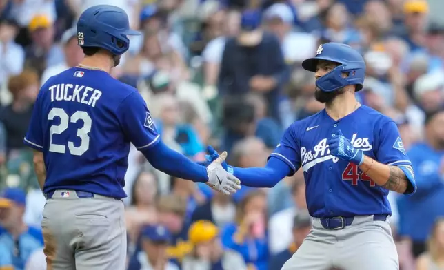 Los Angeles Dodgers' Kyle Tucker (23) greets teammate Andy Pages (44) after Pages hit a two-run home run during the fifth inning of a baseball game against the Milwaukee Brewers, Sunday, May 24, 2026, in Milwaukee. (AP Photo/Kayla Wolf)