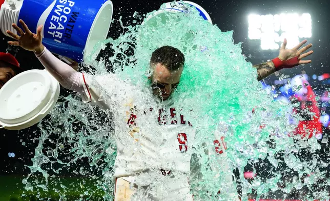 Los Angeles Angels' Zach Neto is douced after hitting a walkoff home run during the ninth inning of a baseball game against the Athletics, Monday, May 18, 2026, in Anaheim, Calif. (AP Photo/William Liang)