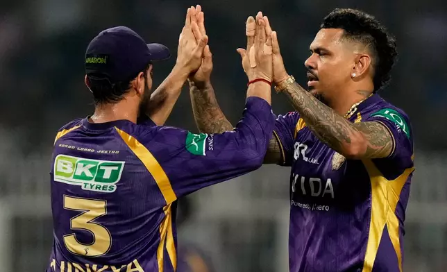 Kolkata Knight Riders' Sunil Narine, right, celebrates with captain Ajinkya Rahane the wicket of Mumbai Indians' captain Hardik Pandya during the Indian Premier League cricket match between Kolkata Knight Riders and Mumbai Indians, in Kolkata , India, Wednesday, May 20, 2026. (AP Photo/Bikas Das)