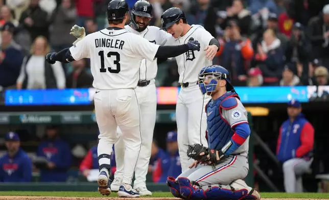 From left to right, Detroit Tigers' Dillon Dingler celebrates after his three-run home run with Riley Greene and Colt Keith as Texas Rangers catcher Danny Jansen looks on during the first inning of a baseball game Saturday, May 2, 2026, in Detroit. (AP Photo/Paul Sancya)