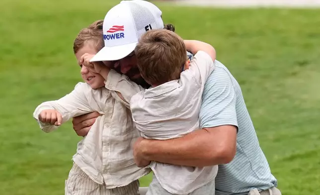 Cameron Young greets his family as he celebrates after winning the Cadillac Championship PGA golf tournament Sunday, May 3, 2026, in Doral, Fla. (AP Photo/David J. Phillip)