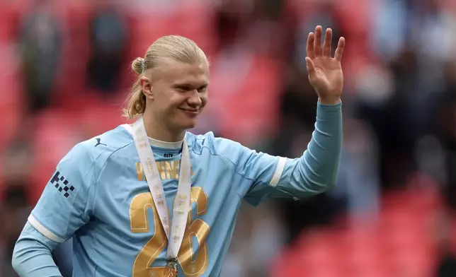 Manchester City's Erling Haaland greets fans after the English FA Cup final soccer match between Chelsea and Manchester City in London, Saturday, May 16, 2026. (AP Photo/Richard Pelham)