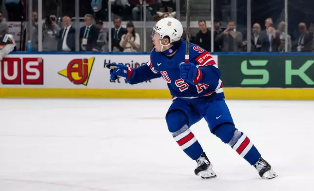 United States' Ryan Leonard celebrates after scoring the decisive goal in the penalty shootout during a Group A preliminary round game between the USA and Germany at the men's ice hockey world championship in Zurich, Switzerland, Wednesday, May 20, 2026. (Andreas Becker/Keystone via AP)