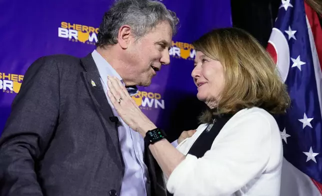 Democratic Ohio Senate candidate Sherrod Brown, a former three-term U.S. senator, left, and wife Connie Shultz react on stage at a primary election night campaign event after Brown won the party's primary for US Senate in Cleveland, Tuesday, May 5, 2026. (AP Photo/Sue Ogrocki)
