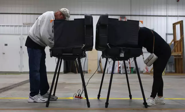 Donna Wooten, right, votes across from her husband, Jerry Wooten in a vote center during a primary election on Tuesday, May 5, 2026, in West Lafayette, Ind. (AP Photo/Cara Penquite)
