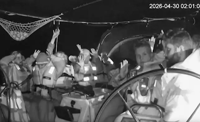 This grab from black and white CCTV footage shows members on flotilla boat with hands in air as Israeli forces intercepted activists who set sail earlier this month from Barcelona attempting to break Israel’s maritime blockade of Gaza, near the southern Greek island of Crete, early Thursday, April 30, 2026. (Global Sumud Flotilla via AP)