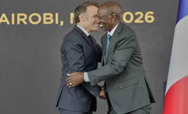 France's President Emmanuel Macron, left, and Kenya's President William Ruto greet each other at State House in Nairobi, Sunday, May 10, 2026. (AP Photo/Brian Inganga)