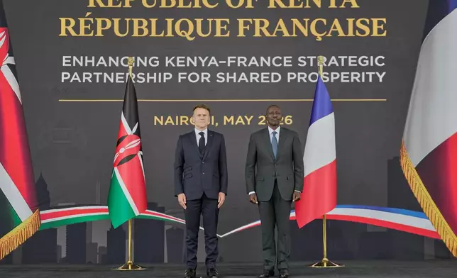 France's President Emmanuel Macron, left, and Kenya's President William Ruto stand during the national anthem at State House in Nairobi, Sunday, May 10, 2026. (AP Photo/Brian Inganga)