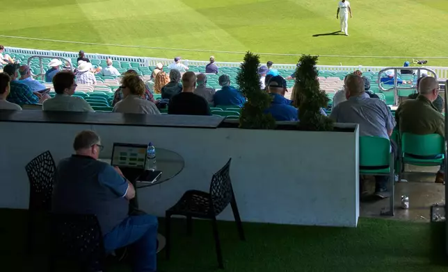 A man works during a Surrey against Sussex County Championship cricket match at the Kia Oval in London, Friday, May 1, 2026. (AP Photo/Tony Hicks)