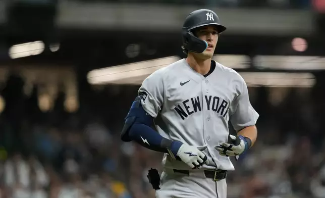 New York Yankees' Spencer Jones jogs to first base after drawing a walk during the fifth inning of a baseball game against the Milwaukee Brewers, Friday, May 8, 2026, in Milwaukee. (AP Photo/Aaron Gash)