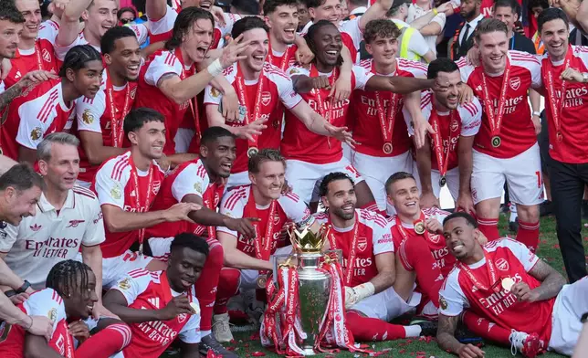 Arsenal players celebrate their Premier League title with the trophy after the English Premier League soccer match between Crystal Palace and Arsenal in London, England, Sunday, May 24, 2026. (AP Photo/Kin Cheung)