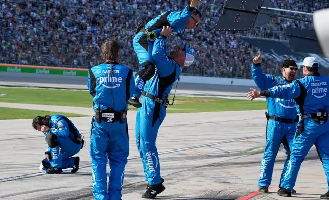 Driver Chase Elliott's pit crew celebrates after he won a NASCAR Cup Series auto race in Fort Worth, Texas, Sunday, May 3, 2026. (AP Photo/Larry Papke)