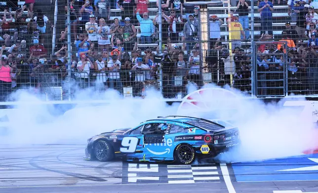 Chase Elliott does a burnout at the finish line after winning a NASCAR Cup Series auto race in Fort Worth, Texas, Sunday, May 3, 2026. (AP Photo/LM Otero)