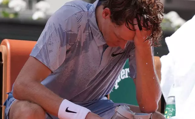 Jannik Sinner of Italy reacts as he cools himself with the water during a break at the second round men's singles tennis match against Juan Manuel Cerundolo of Argentina at the French Open tennis tournament in Paris, Thursday, May 28, 2026, as temperature rises up to 33 C (91 F). (AP Photo/Thibault Camus)