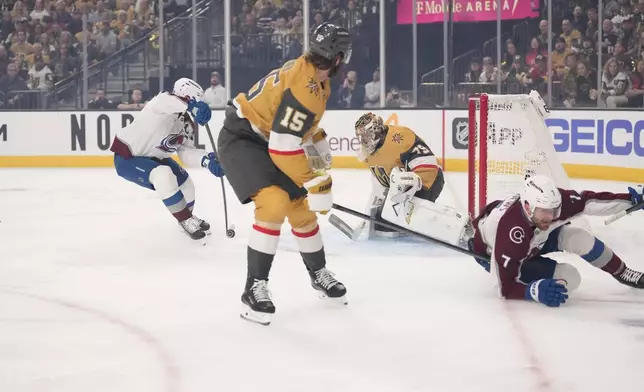 Colorado Avalanche left wing Gabriel Landeskog, left, scores on Vegas Golden Knights goaltender Carter Hart, second from right, as defenseman Noah Hanifin, second from left, and defenseman Devon Toews skate away during the first period in Game 3 of the Western Conference finals NHL hockey Stanley Cup playoff series Sunday, May 24, 2026, in Las Vegas. (AP Photo/Mark J. Terrill)