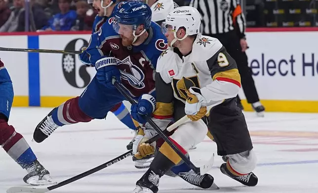Colorado Avalanche left wing Gabriel Landeskog, left, checks Vegas Golden Knights center Jack Eichel during the second period in Game 1 of the Western Conference finals NHL hockey Stanley Cup playoff series Wednesday, May 20, 2026, in Denver. (AP Photo/David Zalubowski)