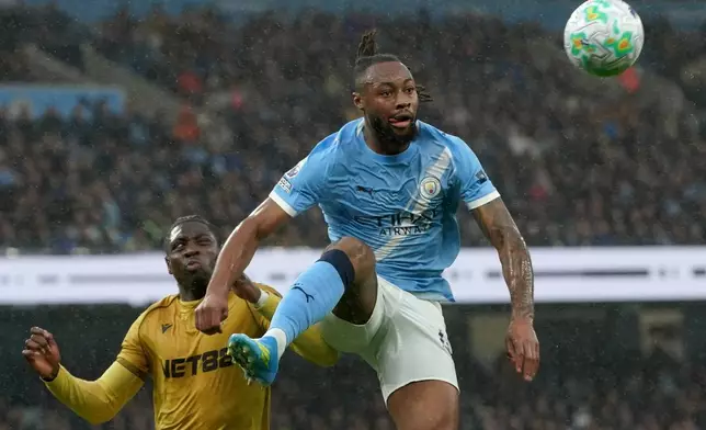 Manchester City's Antoine Semenyo, right, and Crystal Palace's Jaydee Canvot challenge for the ball during the English Premier League soccer match between Manchester City and Crystal Palace in Manchester, England, Wednesday, May 13, 2026. (AP Photo/Ian Hodgson)
