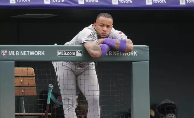 Arizona Diamondbacks designated hitter Ketel Marte leans over the dugout rail as he looks on in the fifth inning of a baseball game against the Colorado Rockies, Saturday, May 16, 2026, in Denver. (AP Photo/David Zalubowski)