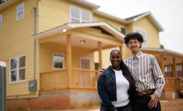 Home owners Phileena Daniel and Oswaldo Herrera pose for a photo in Langston Park, April 13, 2026, in Atlanta. (AP Photo/Mike Stewart)